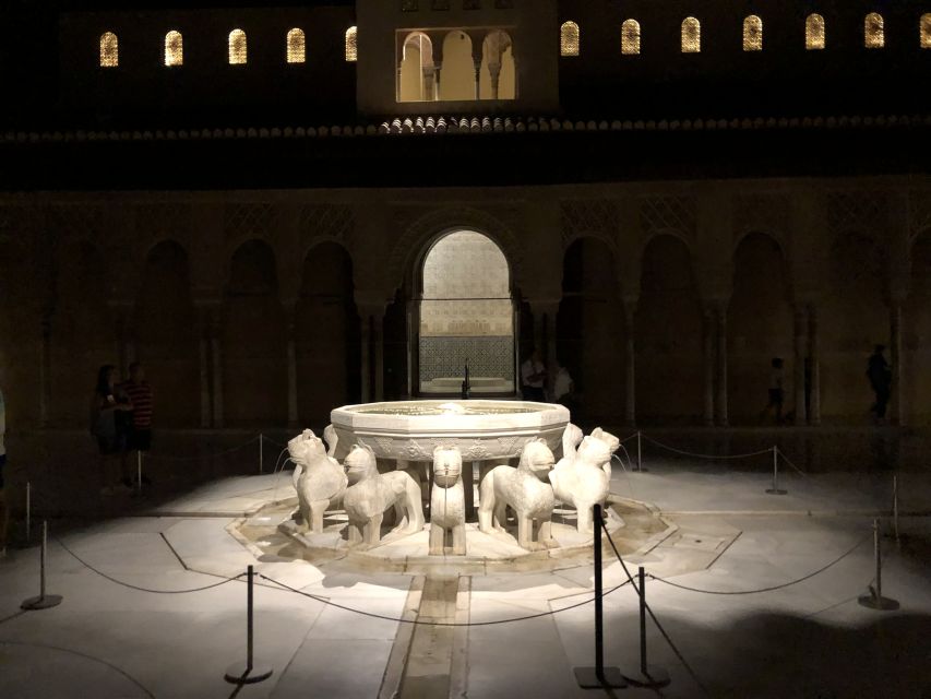 Granada: The Alhambra and Nasrid Palaces Guided Night Tour - Walking through the illuminated gardens